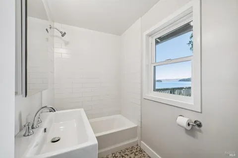 a white bath tub sitting next to a white sink
