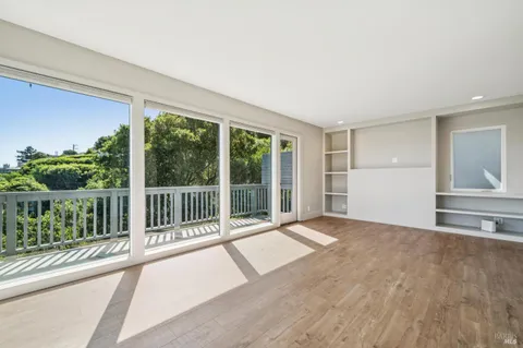 a kitchen with stainless steel appliances granite countertop a refrigerator stove a sink and dishwasher with white cabinets