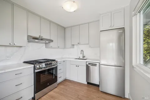 a kitchen with a sink a refrigerator and window