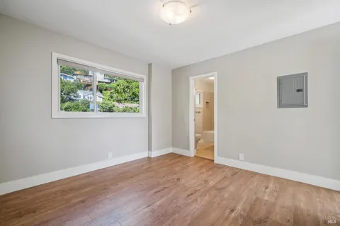 a view of a livingroom with wooden floor and a window