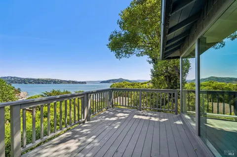a view of balcony with wooden floor and fence