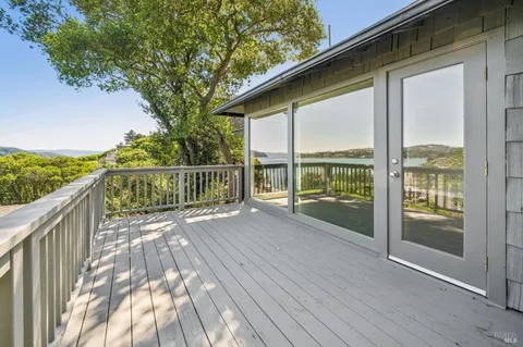 an aerial view of a house with a yard and lake view