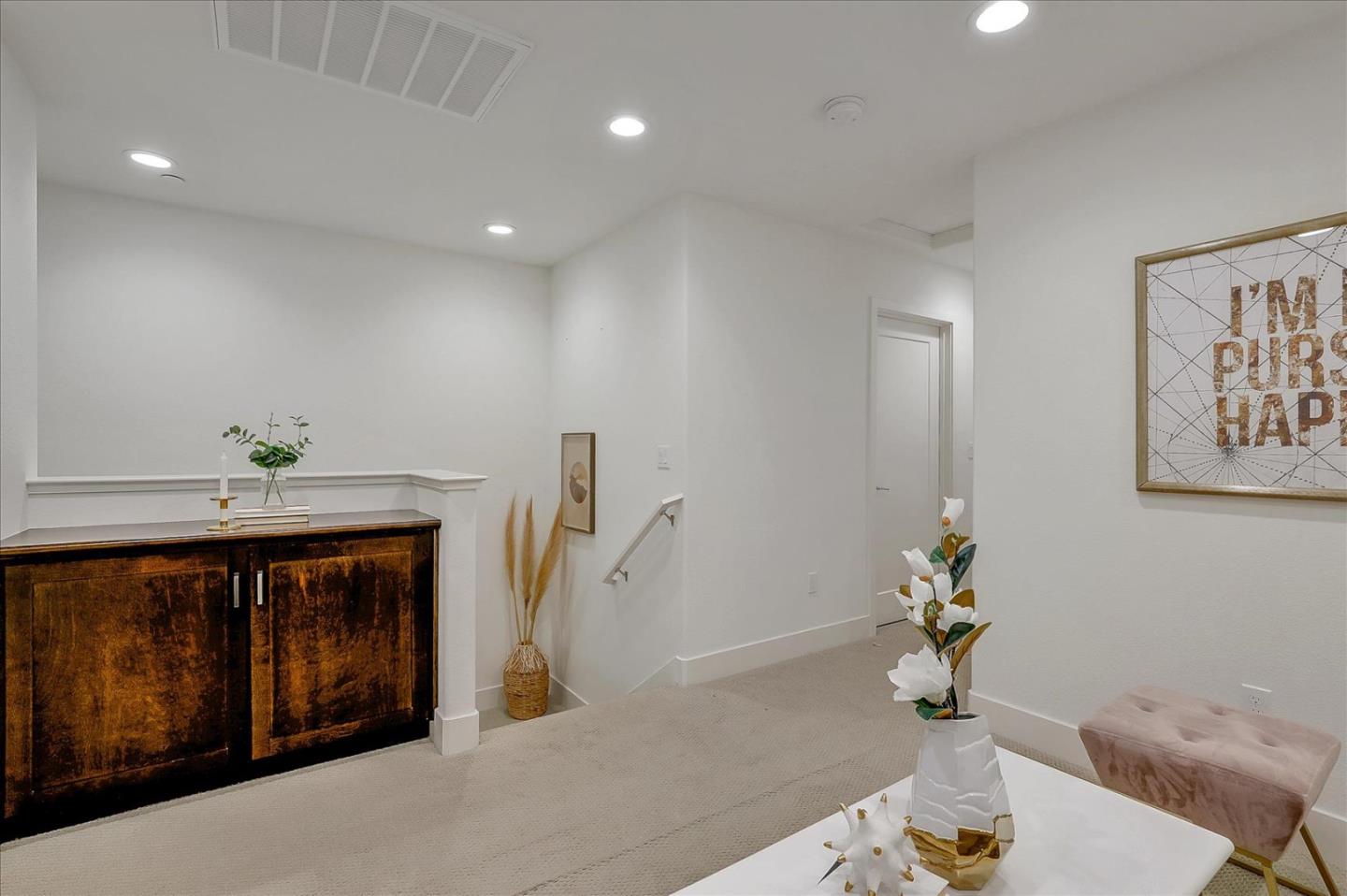 37524 Cape Cod Road, Unit 8 Newark, CA 94560 - Photo 7 of 24 a hallway with a table and a couch