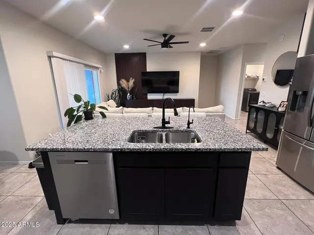 a kitchen with granite countertop a sink and a stove