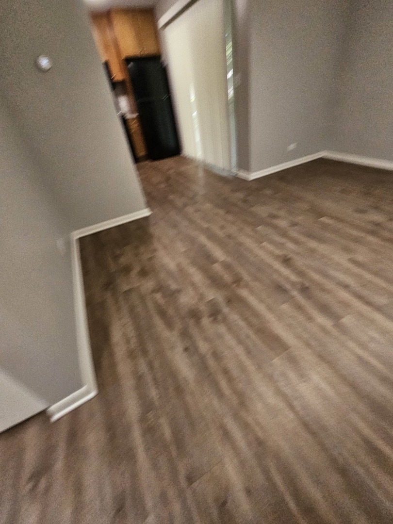 56 North Victoria Lane, Unit C Streamwood, IL 60107 - Photo 2 of 11 a view of a big room with wooden floor