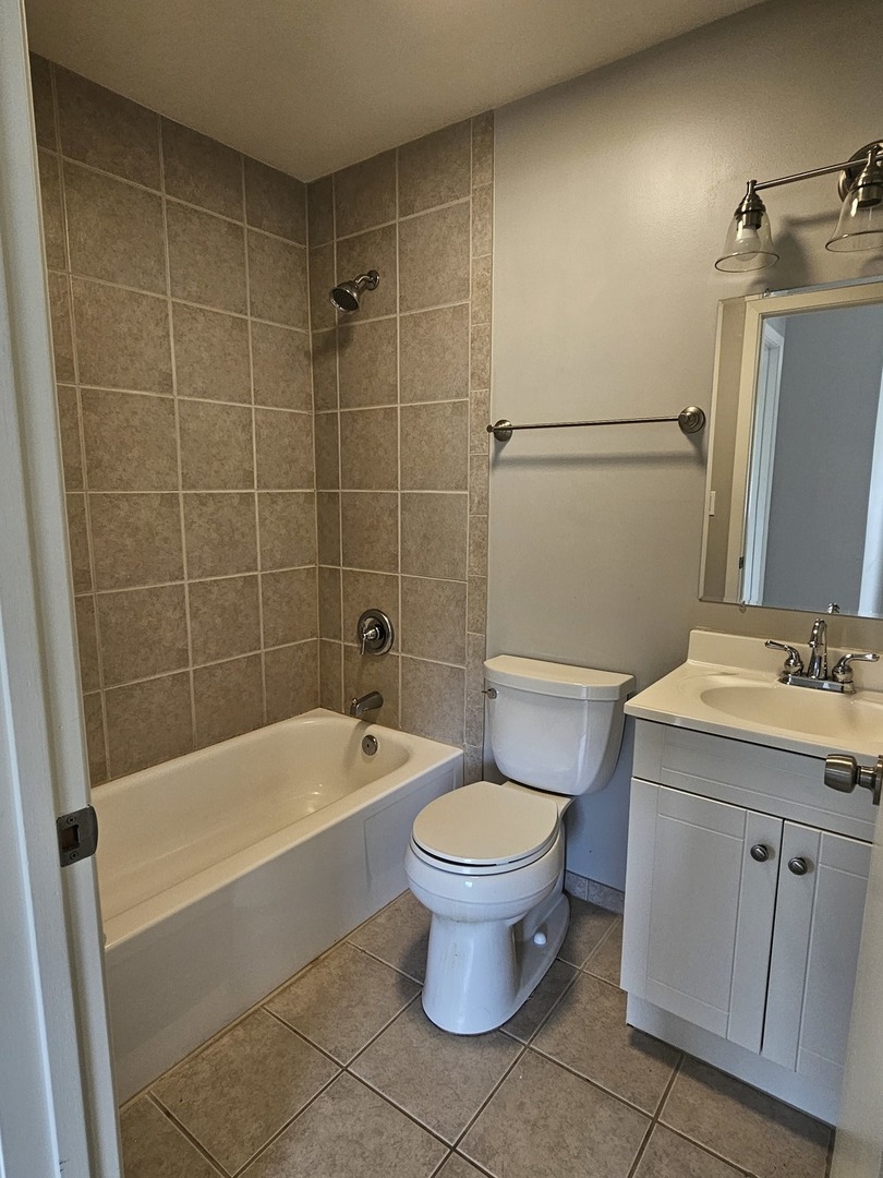 56 North Victoria Lane, Unit C Streamwood, IL 60107 - Photo 9 of 11 a bathroom with a sink toilet and shower