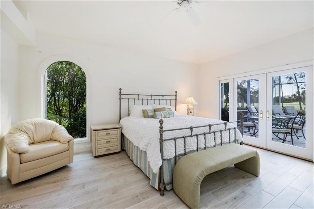 559 Eagle Creek Drive Naples, FL 34113 - Photo 14 of 26 a bedroom with a bed and a couch