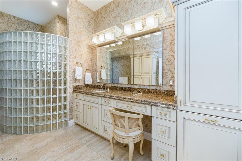 559 Eagle Creek Drive Naples, FL 34113 - Photo 16 of 26 a bathroom with a granite countertop sink and a mirror