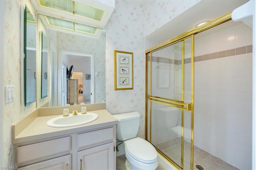 559 Eagle Creek Drive Naples, FL 34113 - Photo 18 of 26 a bathroom with a sink toilet and shower
