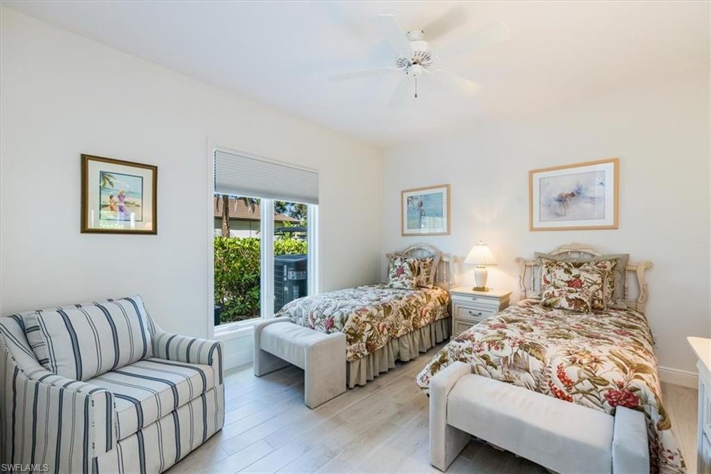 559 Eagle Creek Drive Naples, FL 34113 - Photo 19 of 26 a bedroom with bed couch and window