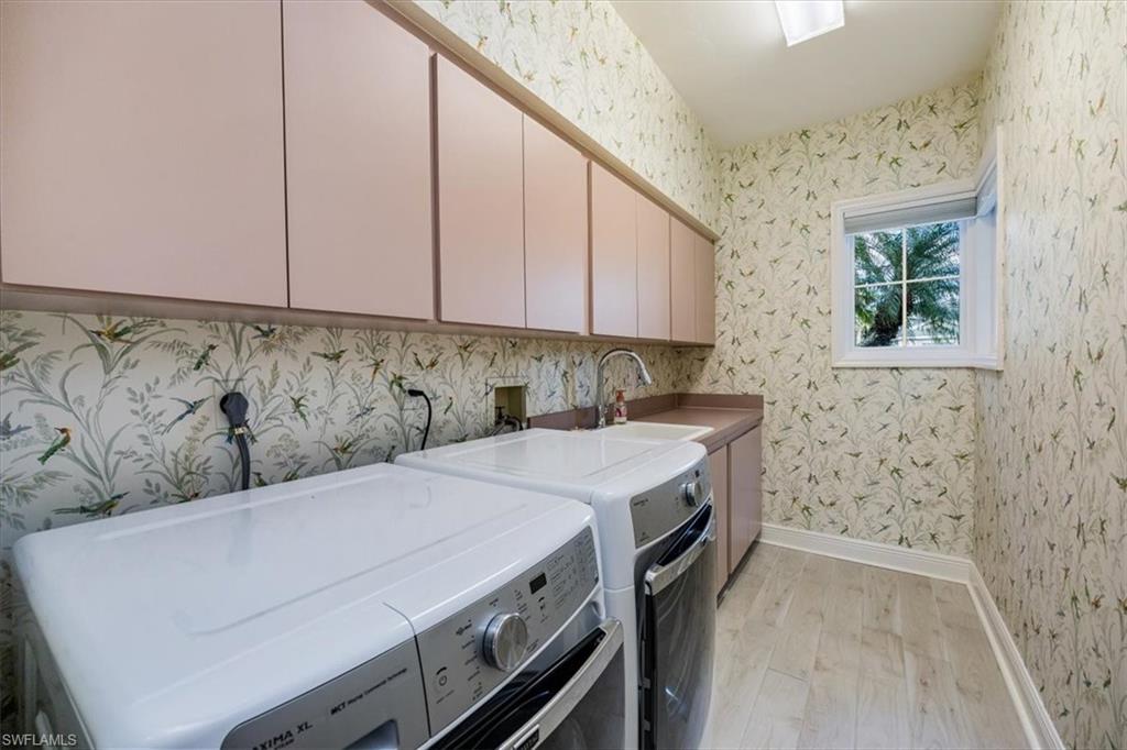559 Eagle Creek Drive Naples, FL 34113 - Photo 23 of 26 a utility room with dryer and washer