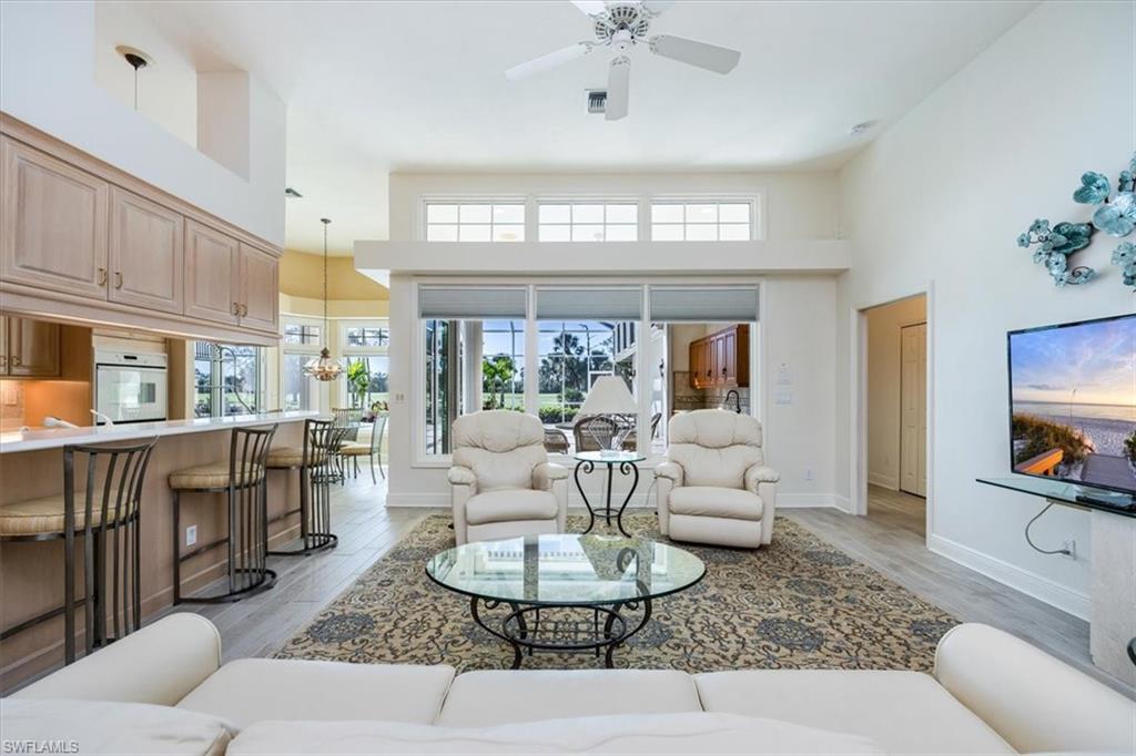 559 Eagle Creek Drive Naples, FL 34113 - Photo 4 of 26 a living room with furniture and a large window