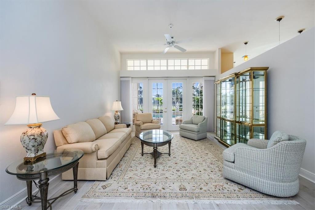 559 Eagle Creek Drive Naples, FL 34113 - Photo 6 of 26 a living room with furniture and a large window