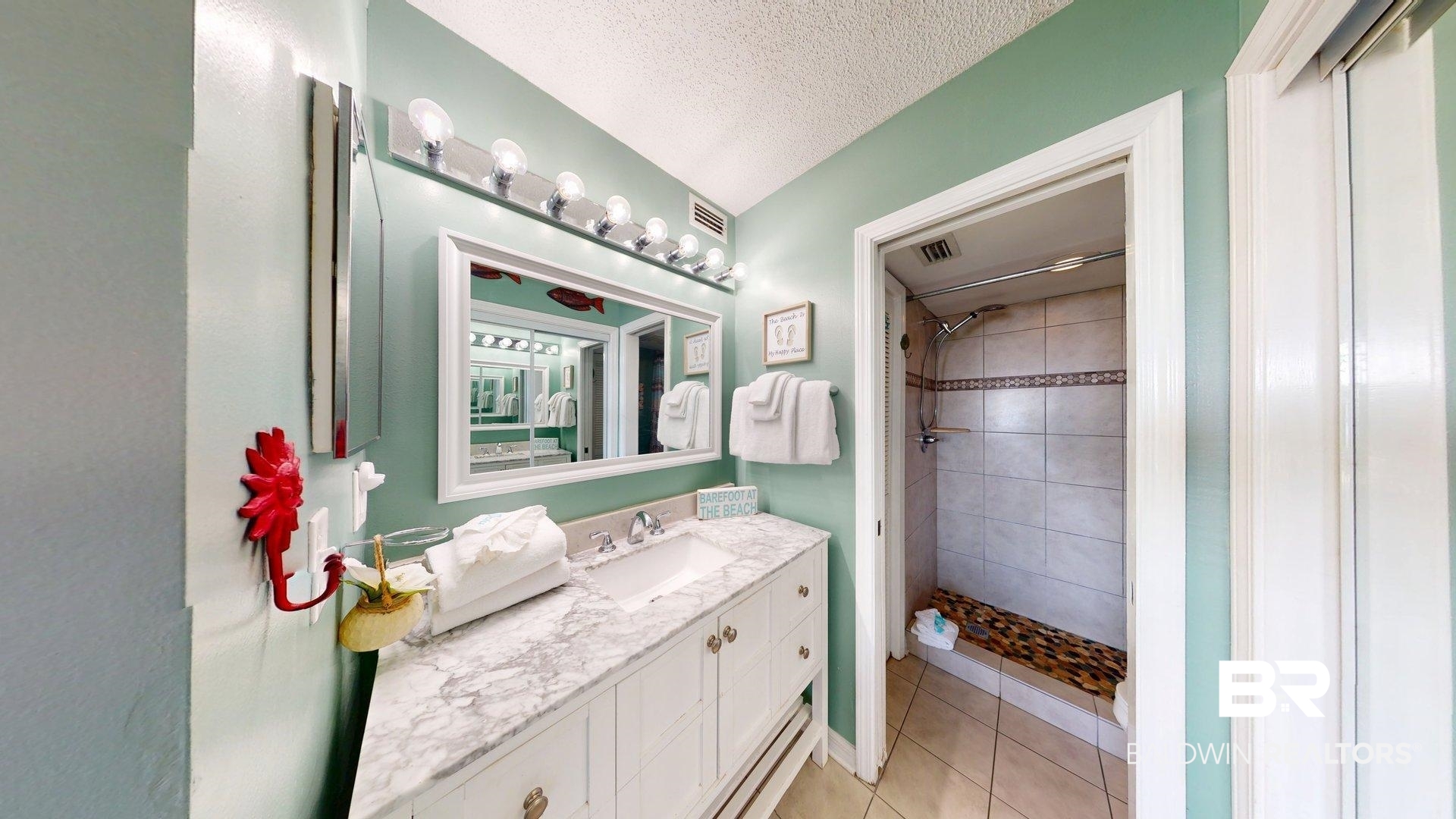 645 Plantation Road, Unit 6503 Gulf Shores, AL 36542 - Photo 40 of 53 Bathroom featuring a textured ceiling, a shower stall, vanity, and light tile patterned floors