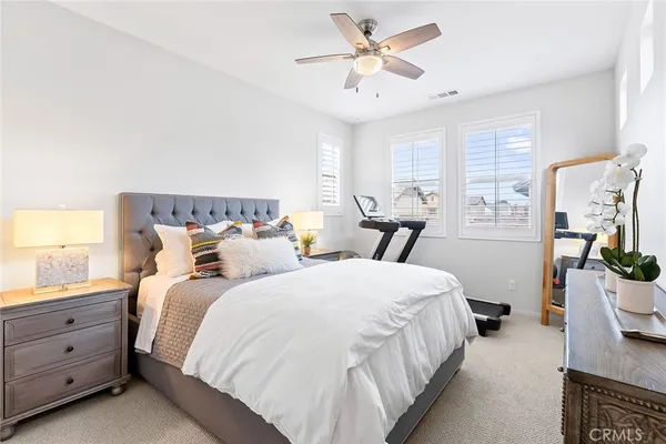 a bedroom with bed and wooden floor