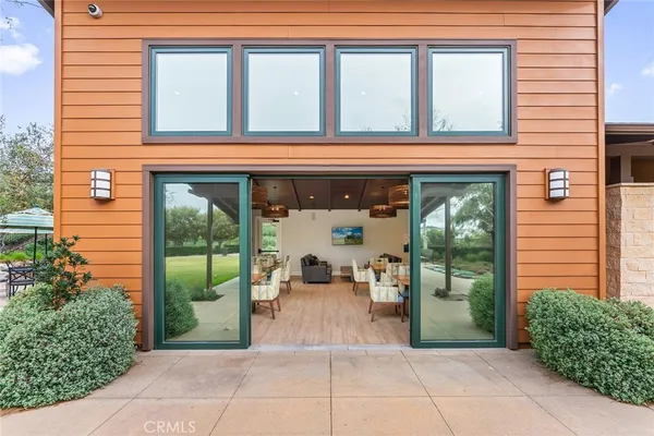 a living room with furniture and a floor to ceiling window