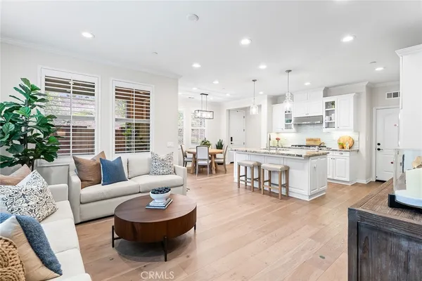 a living room with furniture and a kitchen