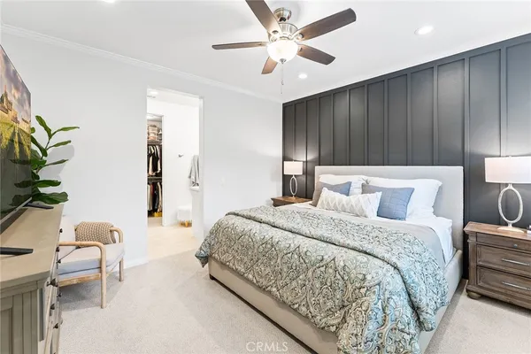 a spacious bedroom with a bed and a potted plant