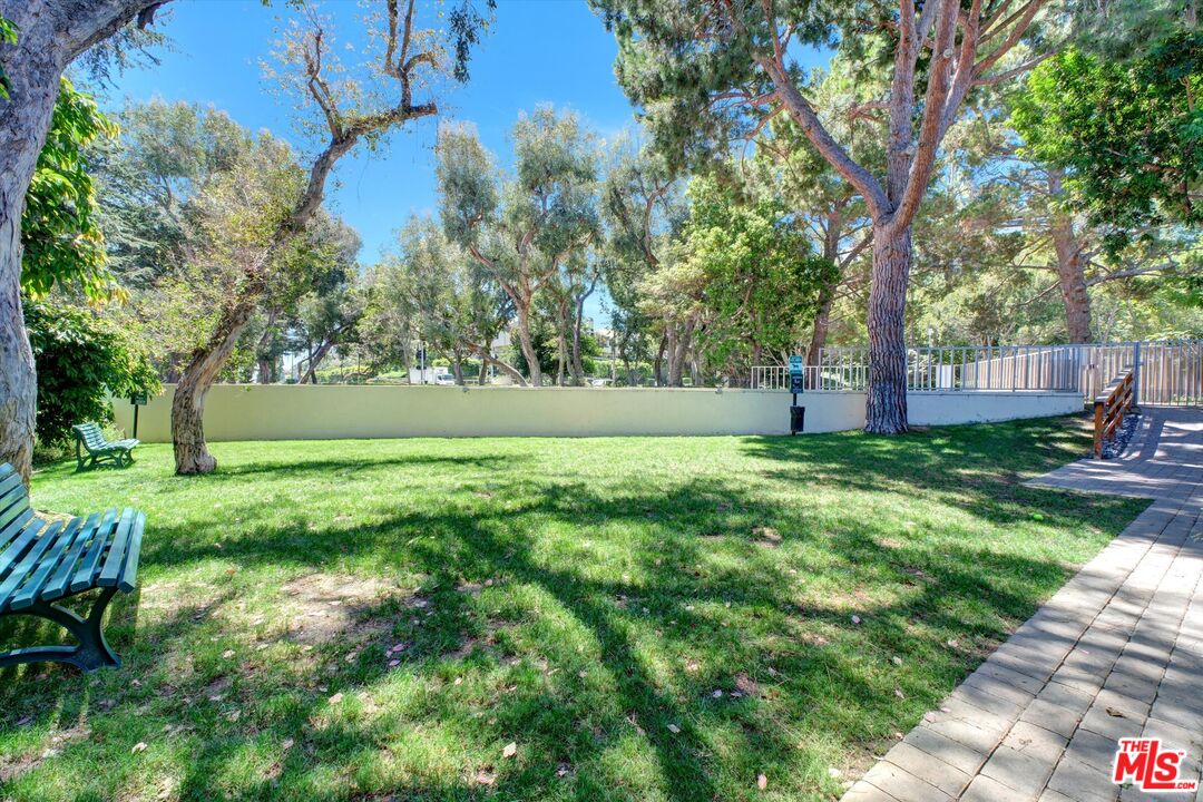 2160 Century Park East, Unit 103 Los Angeles, CA 90067 - Photo 18 of 37 a view of yard with swimming pool and green space