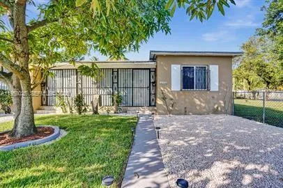 a front view of a house with a garden and yard