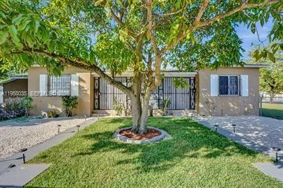 a view of a house with a yard and potted plants