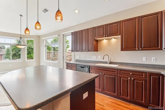 a kitchen with a sink a window and appliances