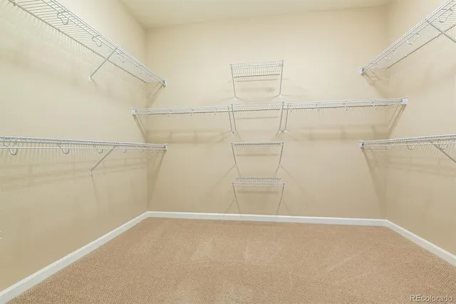 a bathroom with a double vanity sink a mirror and a bathtub