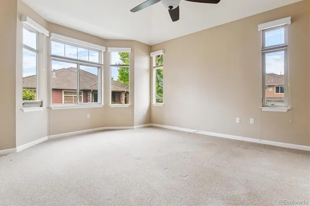 an empty room with windows and entrance