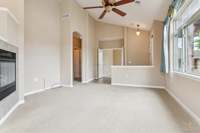 an empty room with windows and entrance