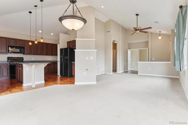 a view of a kitchen with a sink and a refrigerator