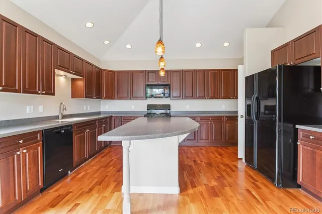 a kitchen with a sink stove and refrigerator
