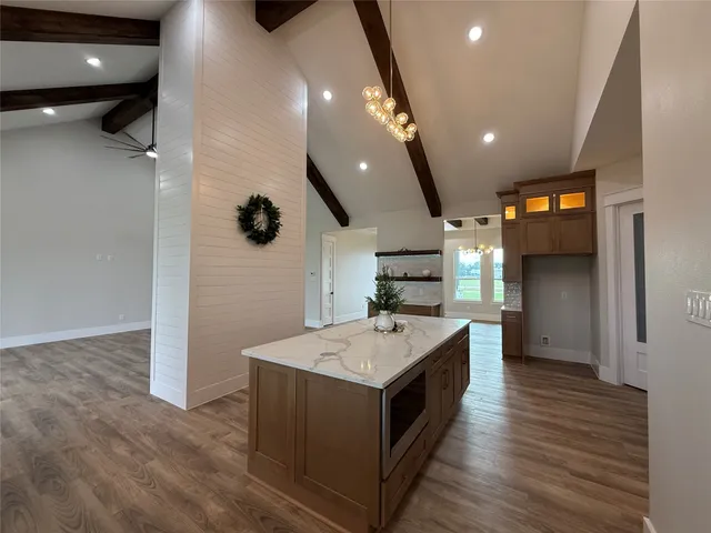 a large kitchen with stainless steel appliances kitchen island granite countertop a large counter top and sink