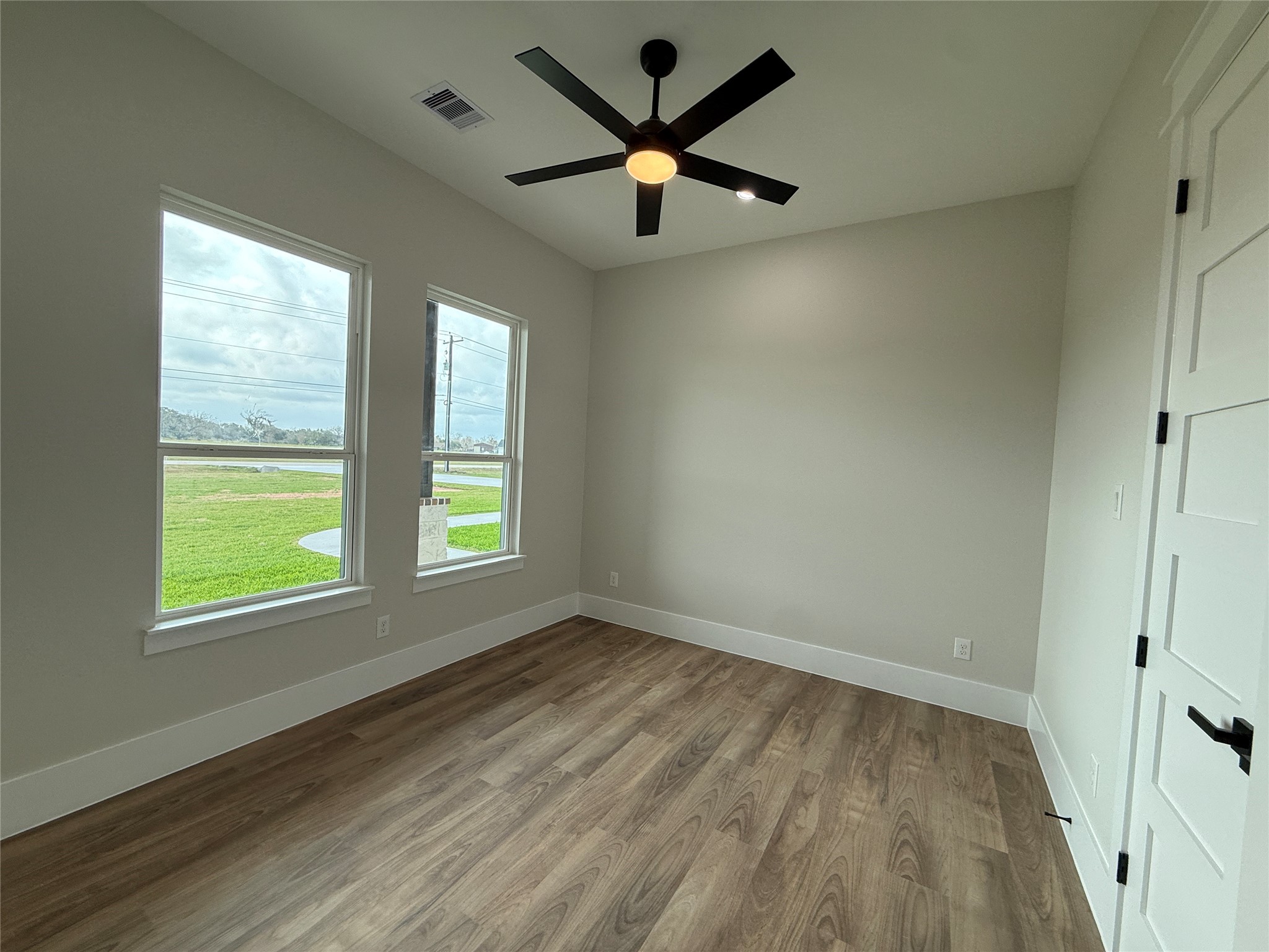 1214 Quarter Horse Trail Angleton, TX 77515 - Photo 23 of 32 wooden floor in an empty room with a window