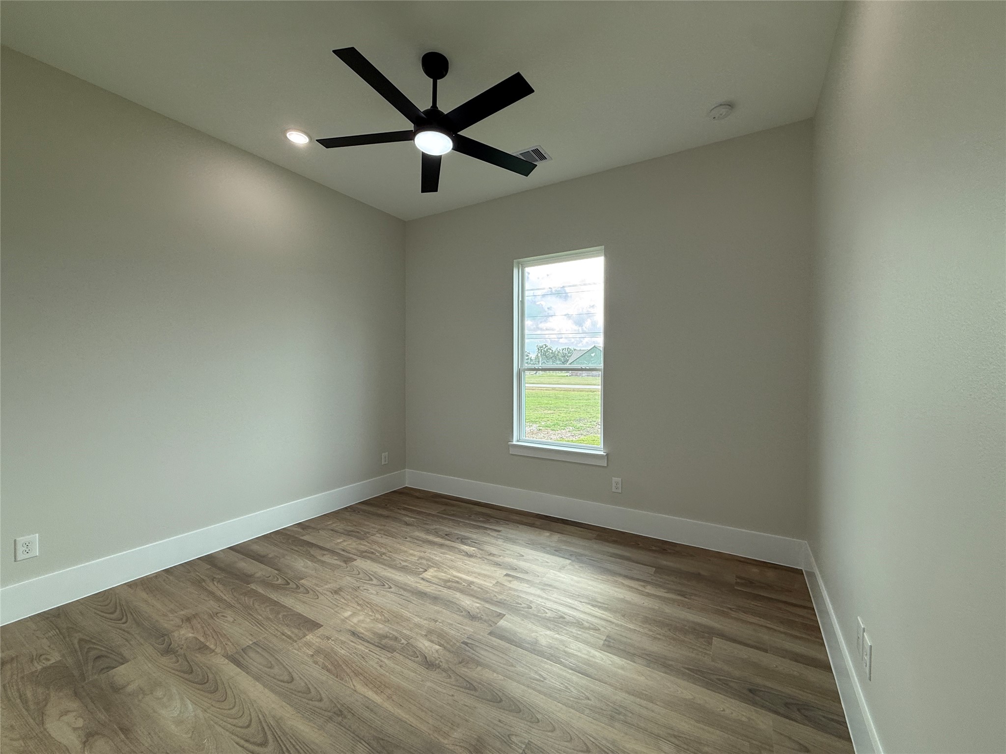 1214 Quarter Horse Trail Angleton, TX 77515 - Photo 25 of 32 an empty room with wooden floor and windows