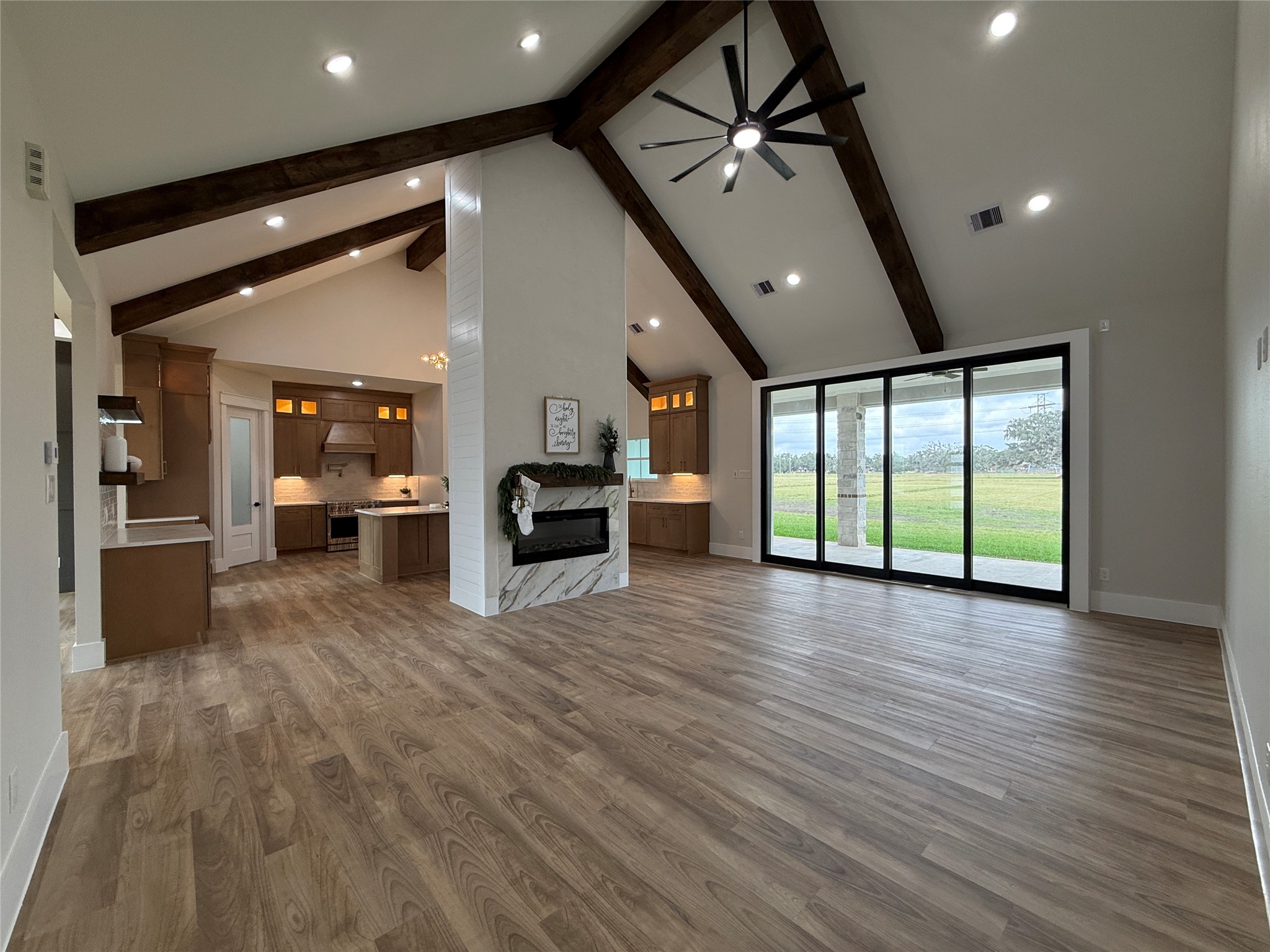 1214 Quarter Horse Trail Angleton, TX 77515 - Photo 6 of 32 a view of an empty room with wooden floor and windows