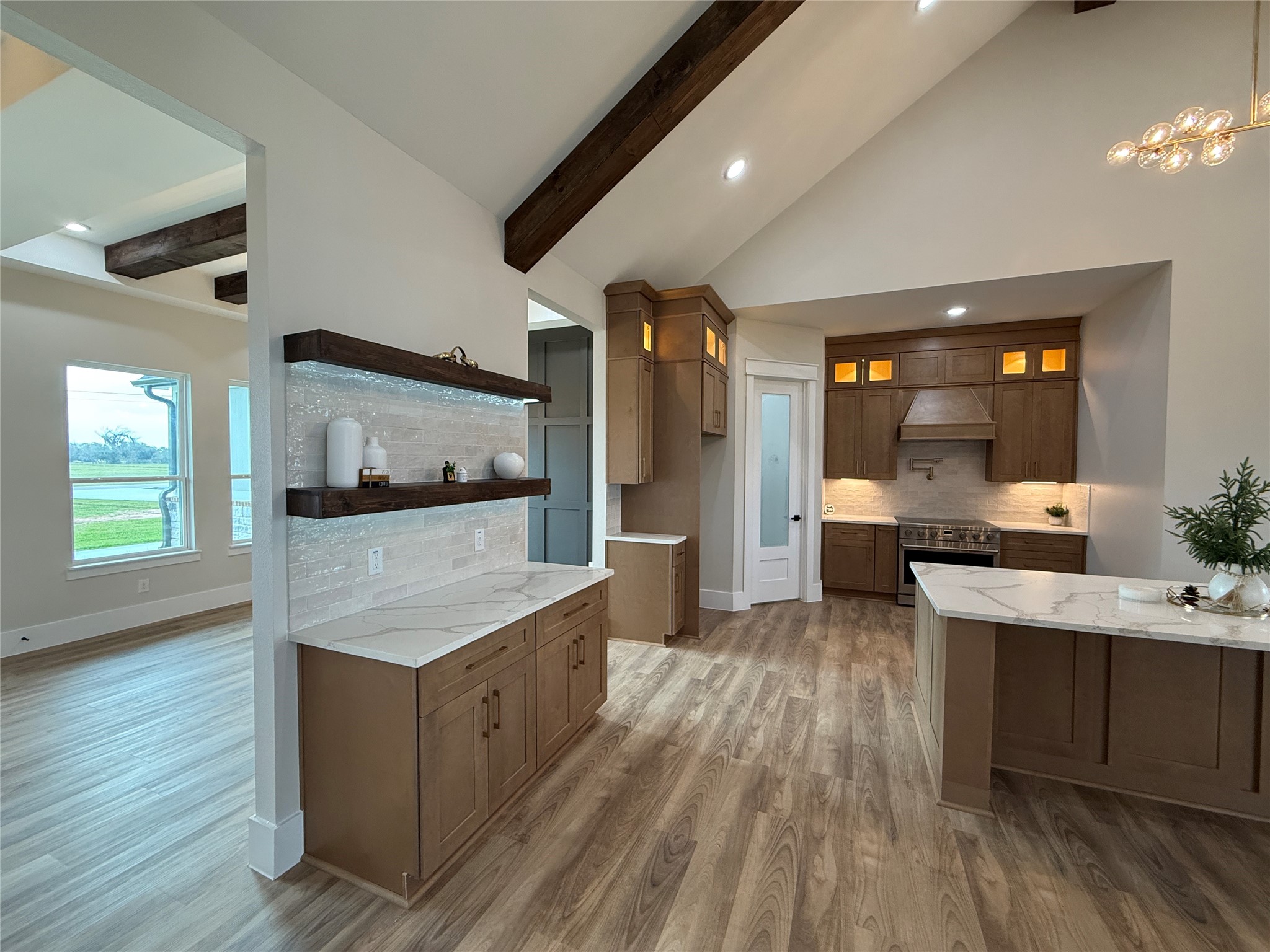 1214 Quarter Horse Trail Angleton, TX 77515 - Photo 8 of 32 a large kitchen with stainless steel appliances kitchen island granite countertop a large counter top and wooden floors