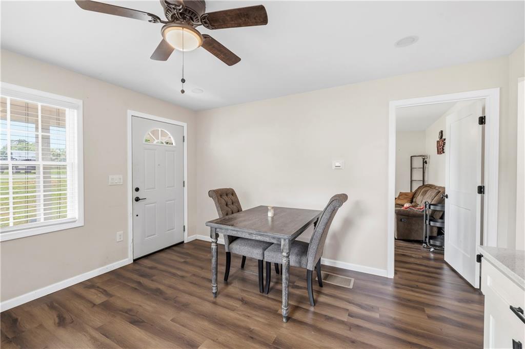 156 Pine Avenue Commerce, GA 30529 - Photo 18 of 35 a view of a dining room with furniture window and wooden floor