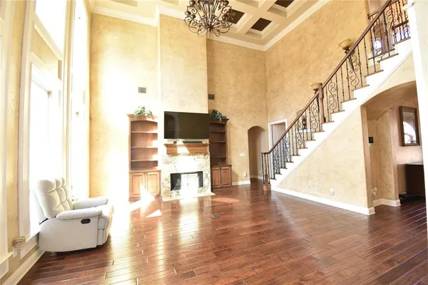a living room with fireplace furniture and a wooden floor
