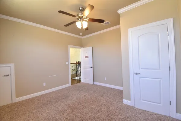 an empty room with closet and fan