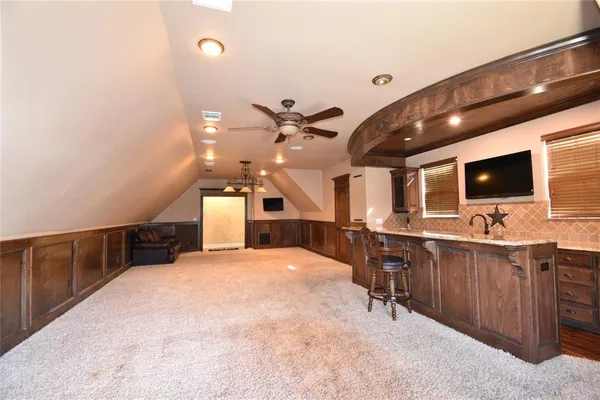 a large kitchen with a table and chairs