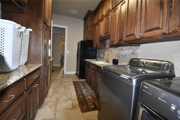 a kitchen with a stove top oven sink and cabinets