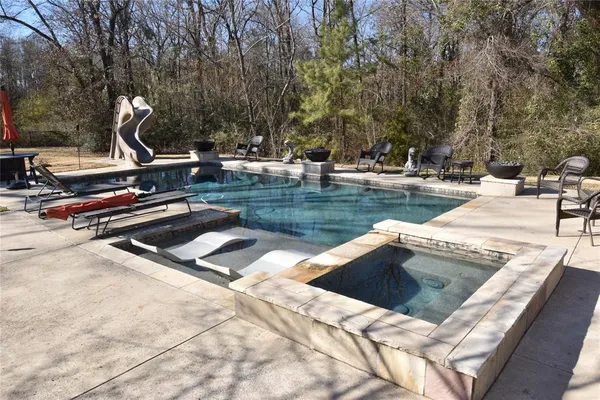 a view of swimming pool with chairs