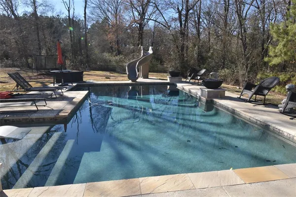 a view of a swimming pool with a patio