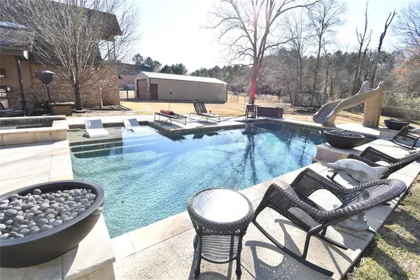 a view of a patio with table and chairs with wooden floor and fence
