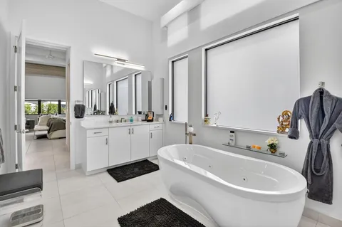 a white bath tub sitting next to a bathroom sink