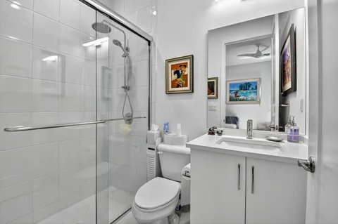 a bathroom with a sink toilet and shower