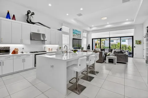 a kitchen with stainless steel appliances kitchen island granite countertop a sink and cabinets
