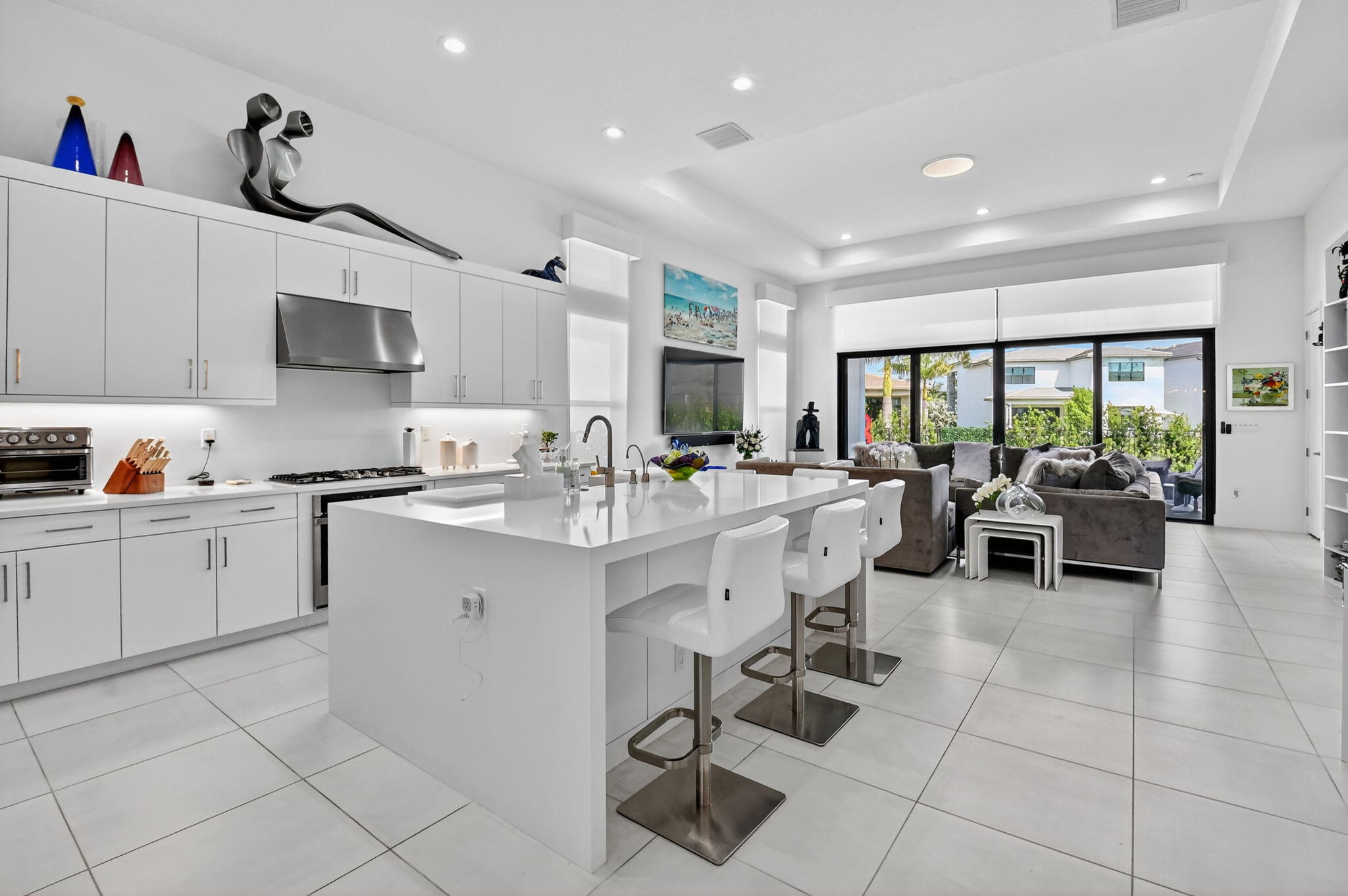 8331 Royal County Down Road Boca Raton, FL 33434 - Photo 3 of 30 a kitchen with stainless steel appliances kitchen island granite countertop a sink and cabinets