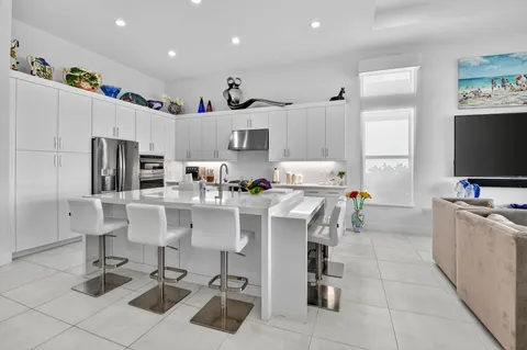 a kitchen with stainless steel appliances kitchen island granite countertop a sink and cabinets