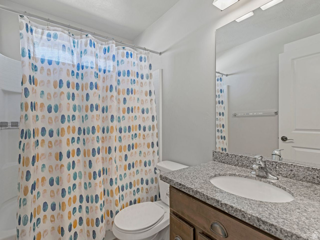 573 South Maxwell Drive Grantsville, UT 84029 - Photo 15 of 25 Full bathroom featuring vanity and curtained shower